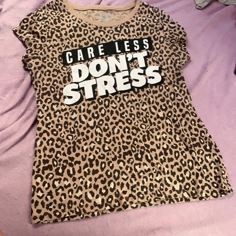 It’s a tan shirt that says “care less don’t stress”